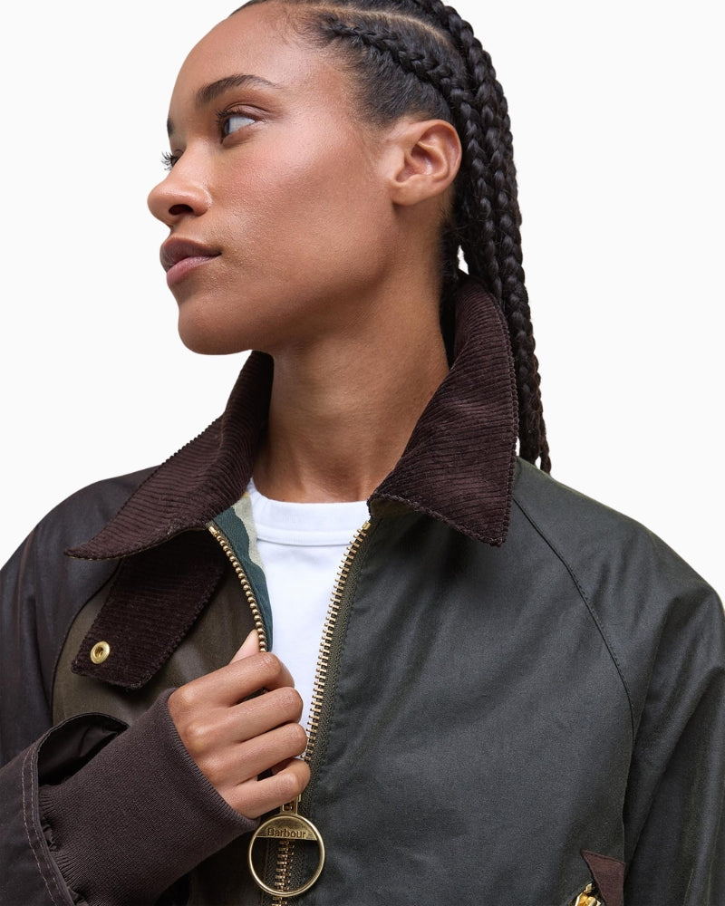 Detail of chunky ring-pull zip and waxed cotton texture on Barbour Arlene jacket