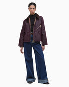 Model wearing Barbour Arlene rustic waxed jacket styled with trousers