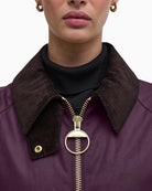 Detail of chunky metal zip and rustic waxed cotton texture on Barbour Arlene jacket