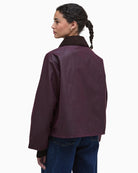 Back view of Barbour Arlene rustic waxed jacket with ribbed cuffs and neat cropped cut