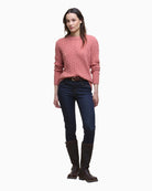 Model styled in the pink jumper with denim jeans