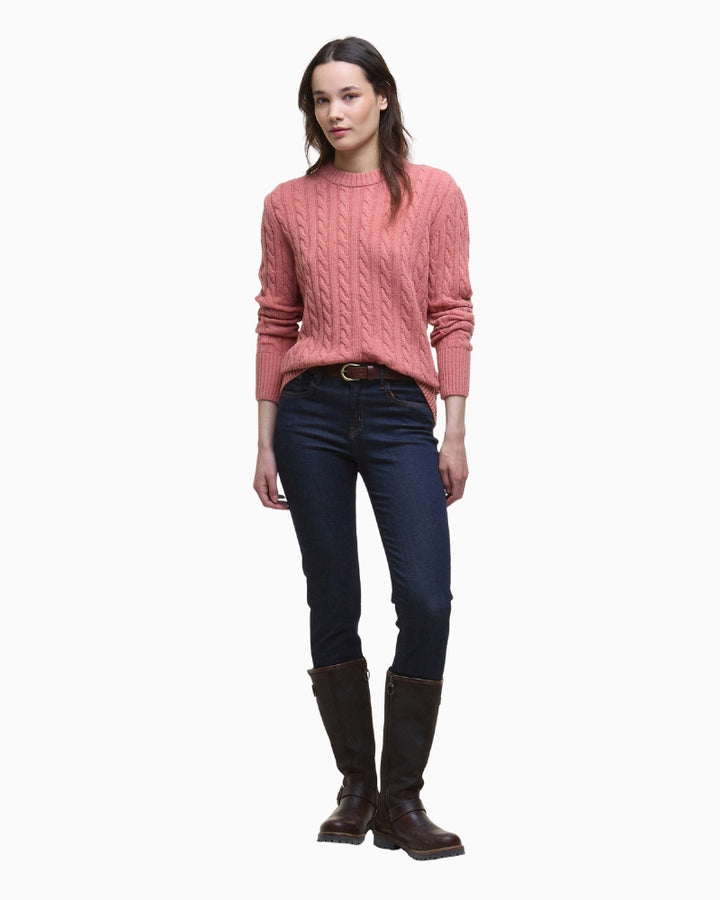 Model styled in the pink jumper with denim jeans