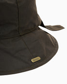 Barbour Brambling Wax Bucket Hat in Olive logo badge detail