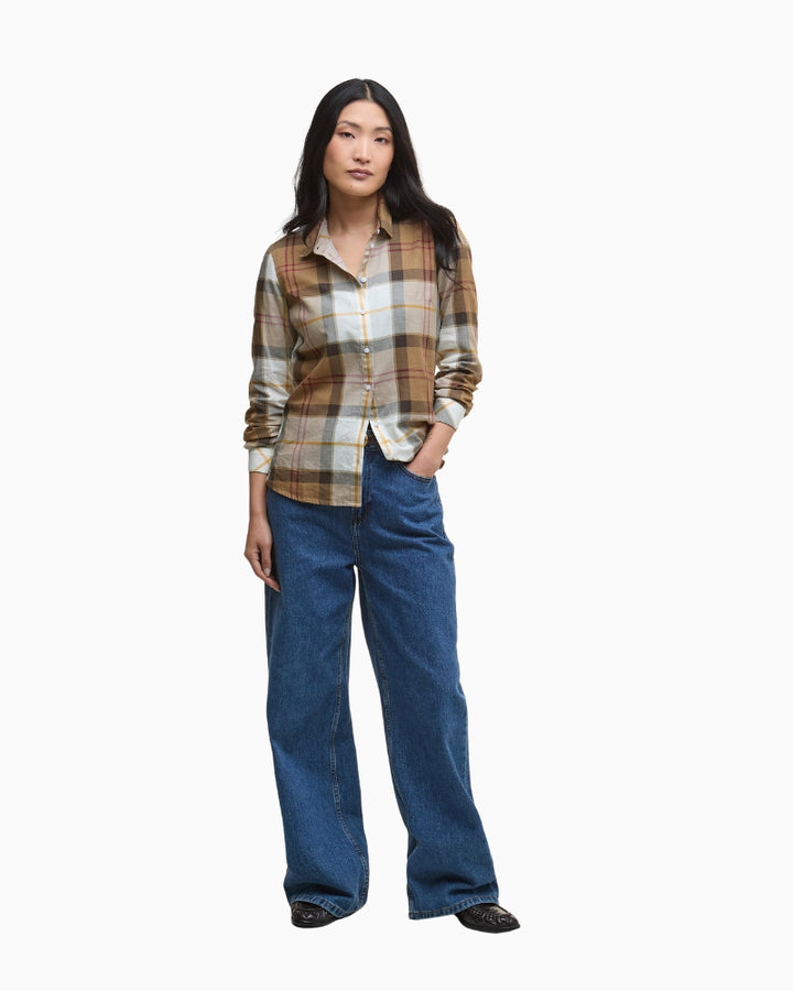 Model styling the shirt tucked into jeans