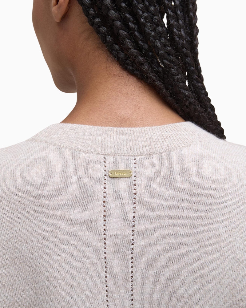 Detail shot of slim metal ID bar at back neck of Barbour jumper