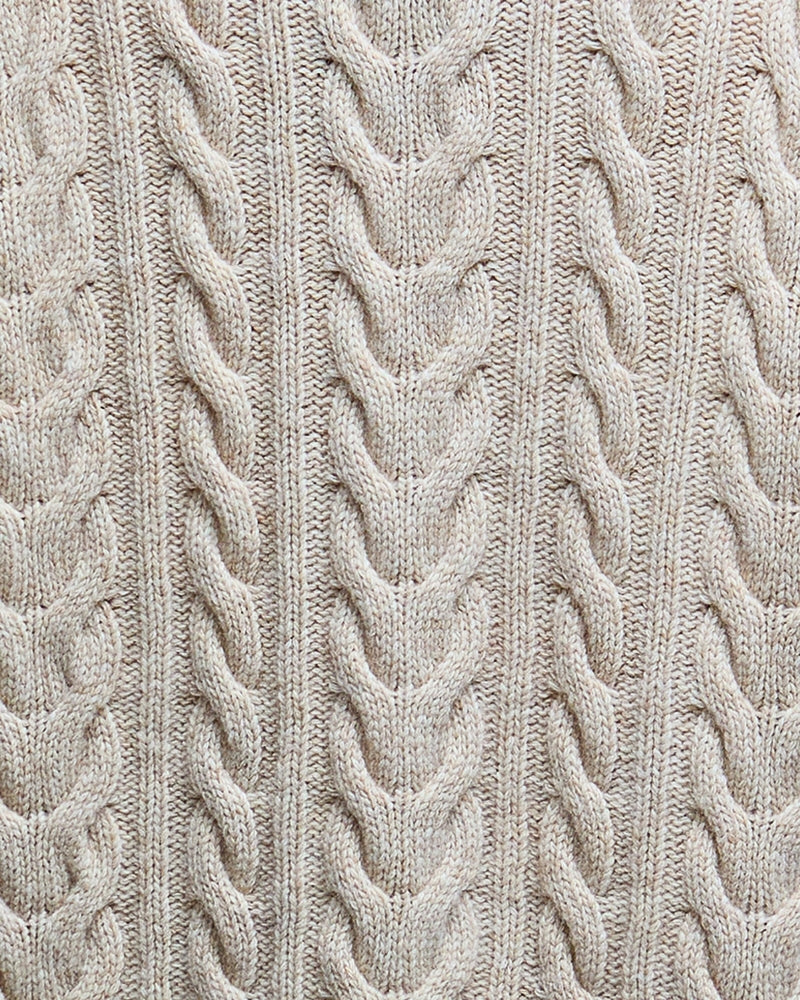 Close-up of cable knit detail on birch Barbour rollneck jumper