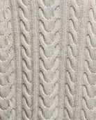 Close-up of cable knit detail on birch Barbour rollneck jumper