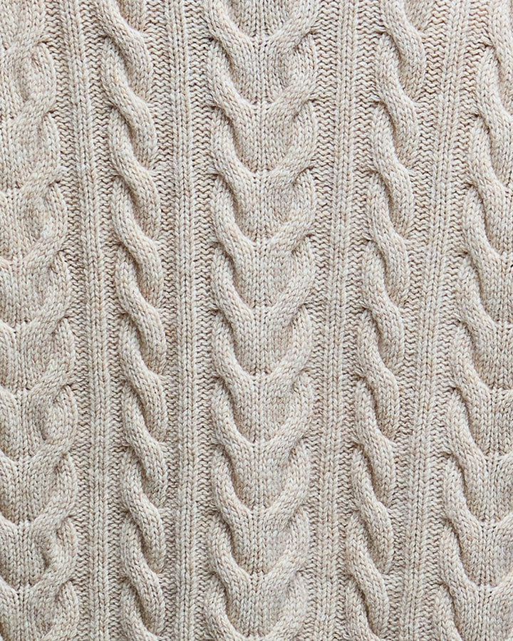 Close-up of cable knit detail on birch Barbour rollneck jumper