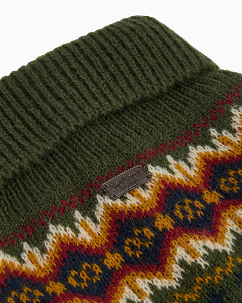 Close-up of Fair Isle pattern on olive acrylic knit fabric with Barbour detailing