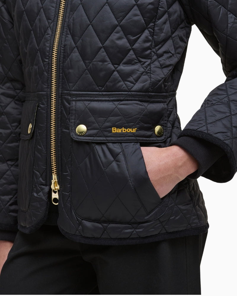 Side silhouette showing fitted waist, dipped hem, and fleece layering