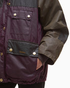 Side view of waxed cotton coat with patch pockets and snap buttons