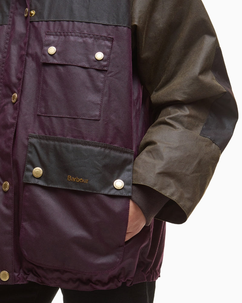 Side view of waxed cotton coat with patch pockets and snap buttons