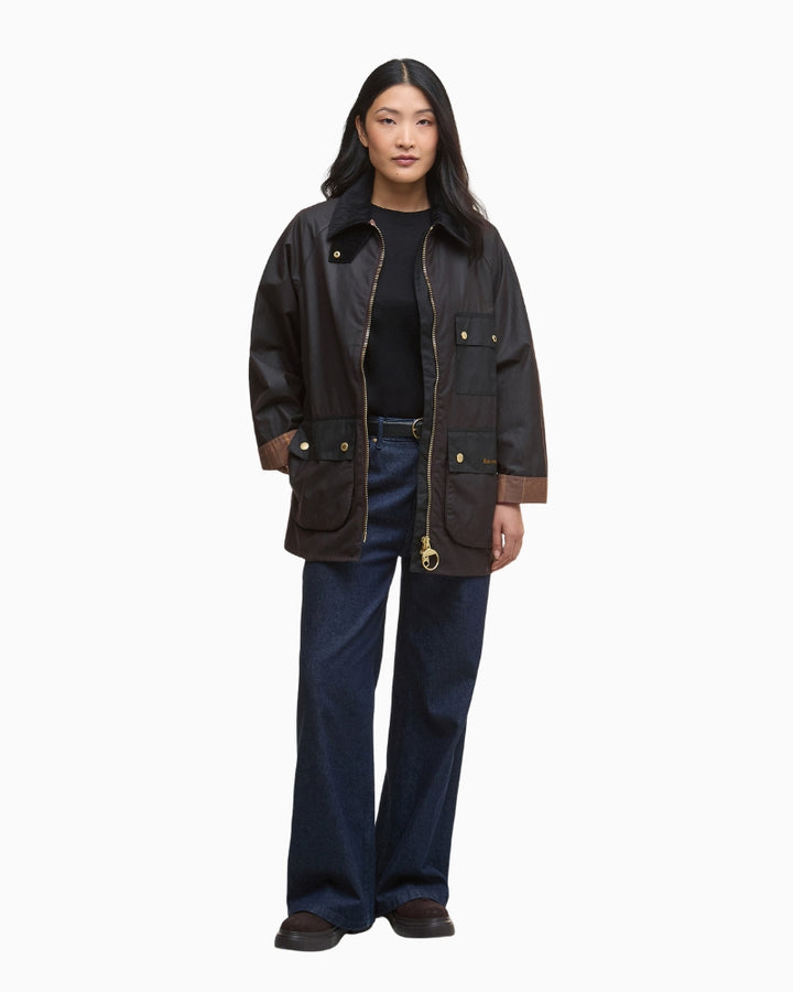 Model wearing black Barbour Luella over knit and jeans