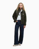 Model wearing fleece outdoors styled with jeans and shoes