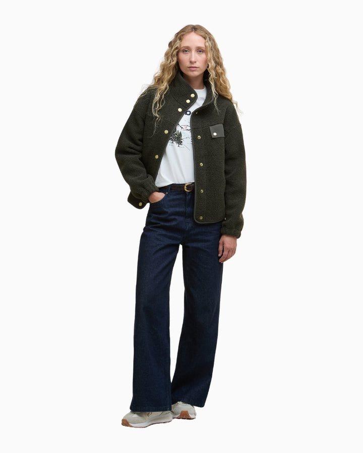 Model wearing fleece outdoors styled with jeans and shoes