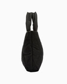 Side profile of Barbour black quilted mini tote showing slim shape and optional crossbody strap