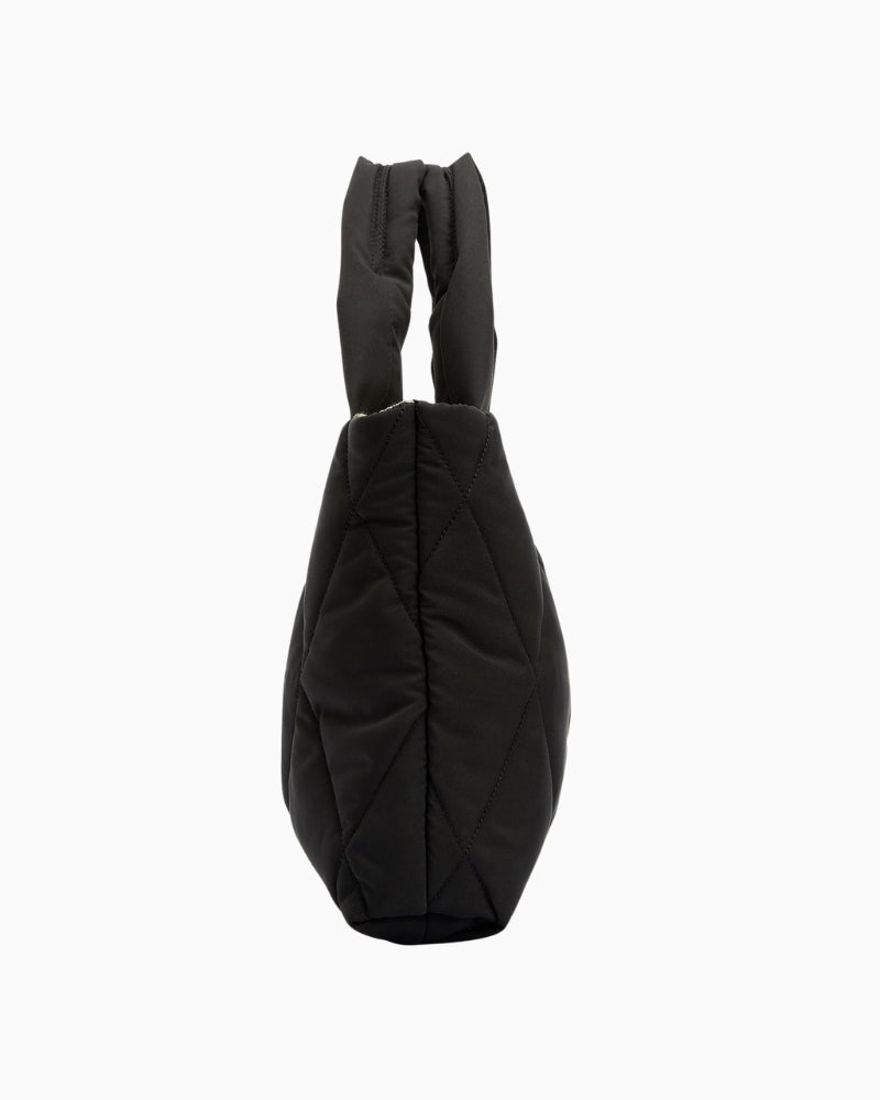 Side profile of Barbour black quilted mini tote showing slim shape and optional crossbody strap