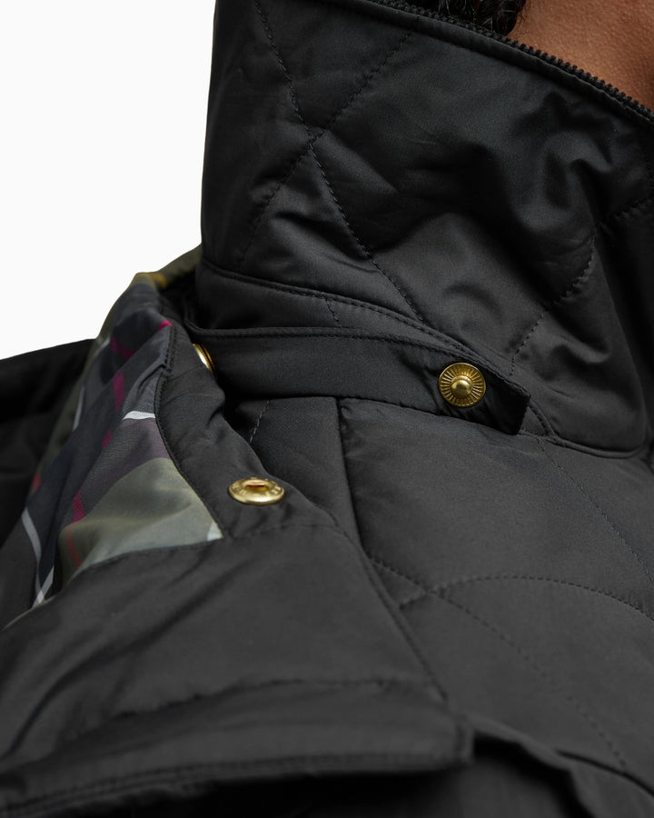 Close-up of gold-tone buttons and cord collar detail