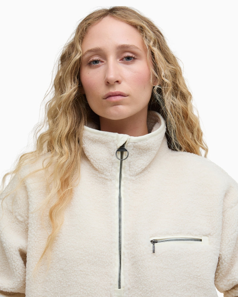 Close-up of half-zip funnel neckline on Barbour Mersea fleece in natural