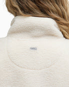 Detailed view of Barbour logo badge at the back of the neck on Mersea fleece