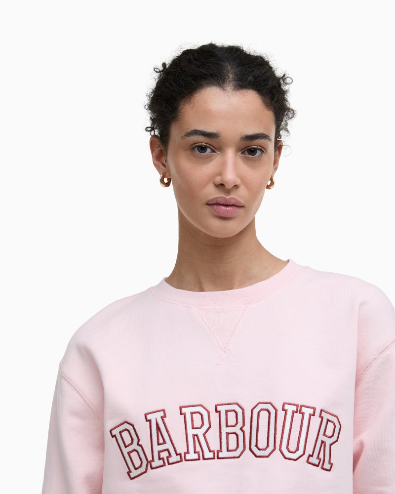 Close-up of Barbour embroidered logo on pink sweatshirt