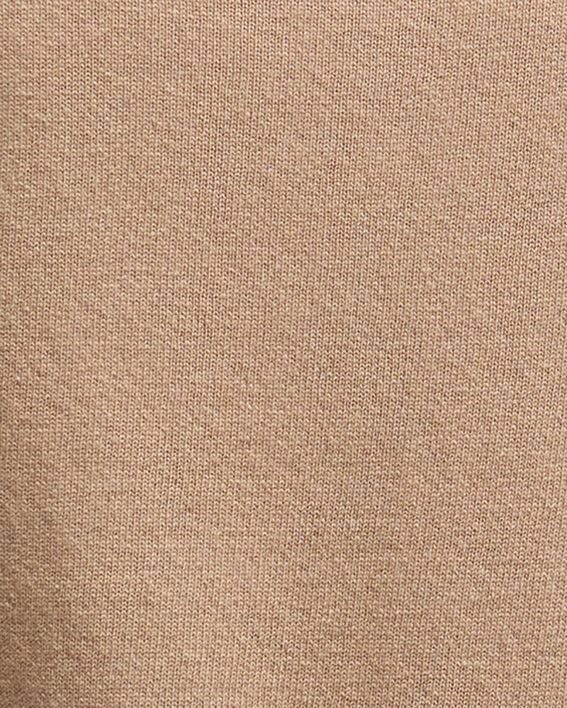 Zoomed-in view of fabric showing fine knit detail and soft camel colouring