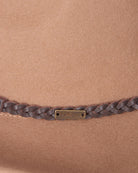 Close-up of leather belt trim on camel fedora hat