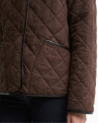 Barbour quilted jacket dark brown button front pocket detail