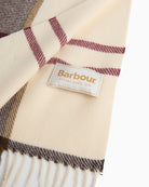 Barbour scarf label detail on cream tartan fabric