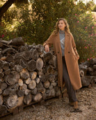 Model wearing Bariloche camel coat over knit and jeans