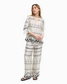 Woman wearing Bariloche Lodosa blouse in white and black, full body front view – Áines Boutique