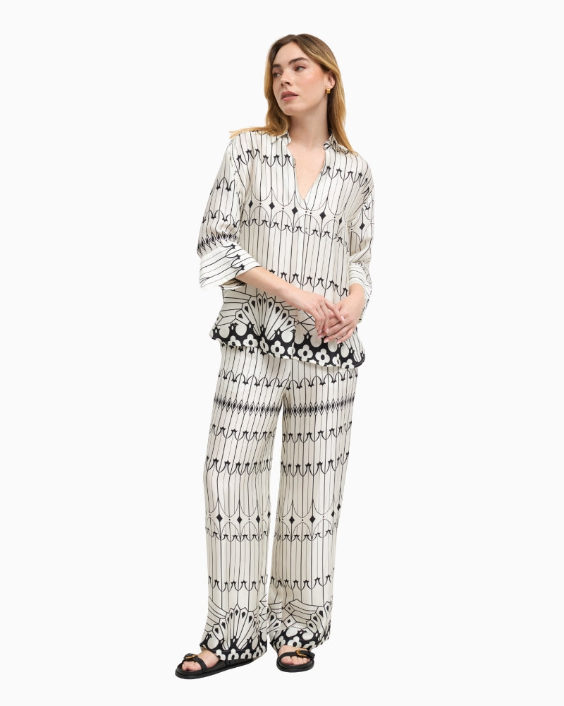 Woman wearing Bariloche Lodosa blouse in white and black, full body front view – Áines Boutique