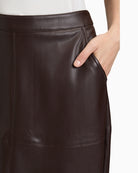 Close-up of pocket detail and leather-like texture on midi skirt