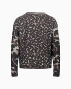 Back view of casual chunky knit showing floral texture and hip-length fit