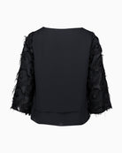 Back view of plain coloured overblouse with long sleeves