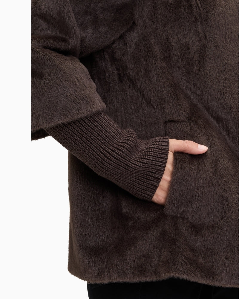 Close up of Plush A-line jacket with stand-up collar and press-stud front