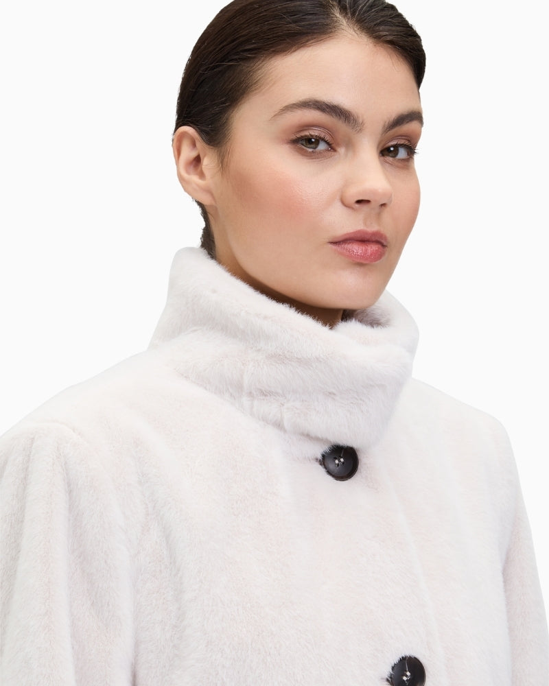 Close-up of piped pocket and plush fabric on women’s short jacket