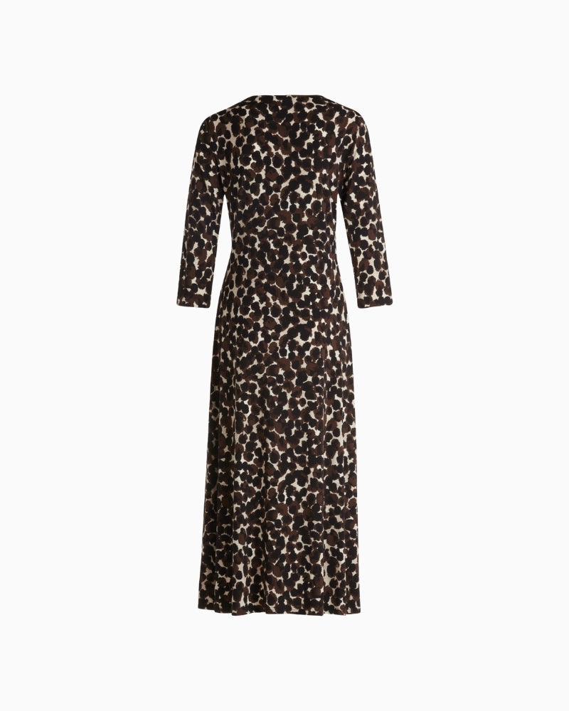 Back view of close-fitting jersey midi dress showing soft drape and dot print

