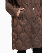 Close up of Long quilted jacket by Betty Barclay with hood and piped pockets