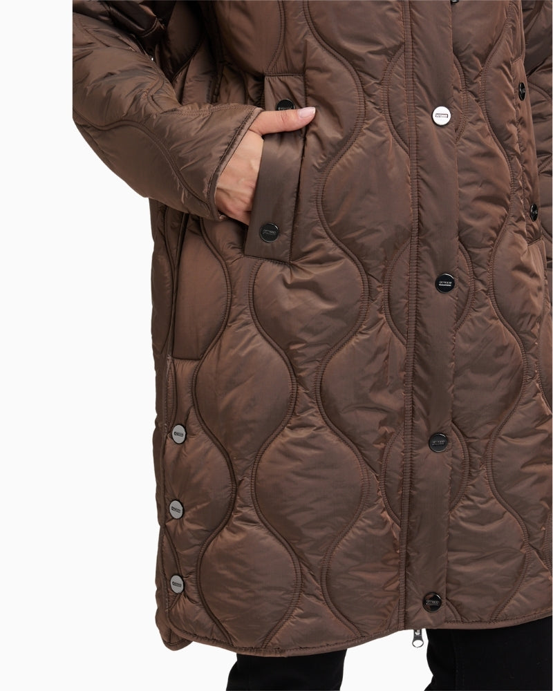 Close up of Long quilted jacket by Betty Barclay with hood and piped pockets