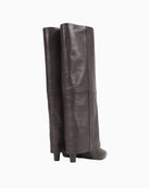 Back of Tall brown leather skirt boots by BRONX with banana heel