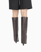 Tall brown leather skirt boots by BRONX with banana heel