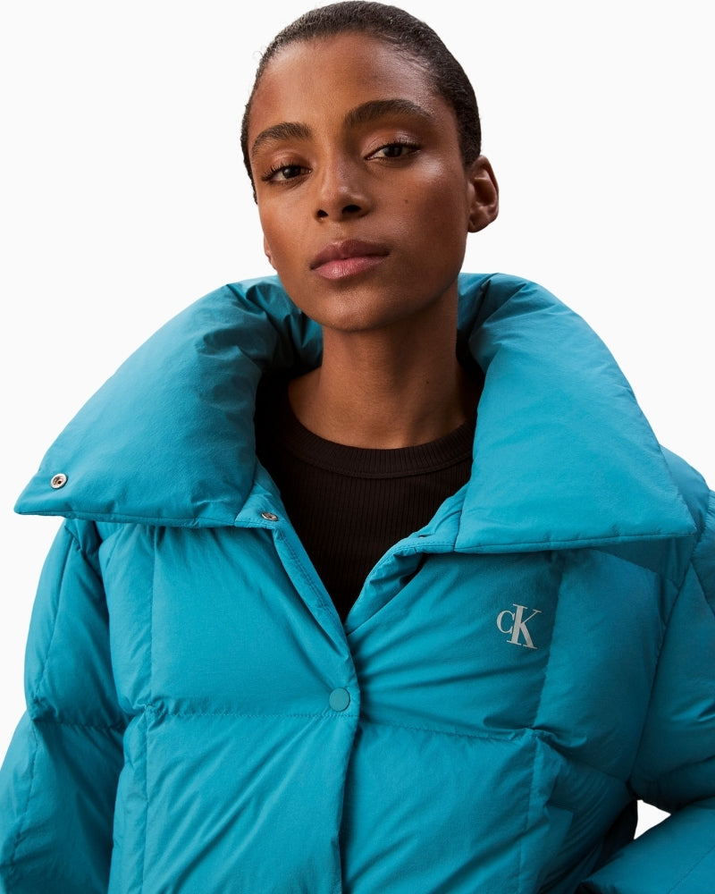 Close-up of high collar on CK Jeans teal puffer jacket