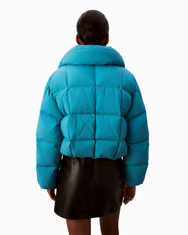 Back view of cropped teal puffer jacket with quilted design

