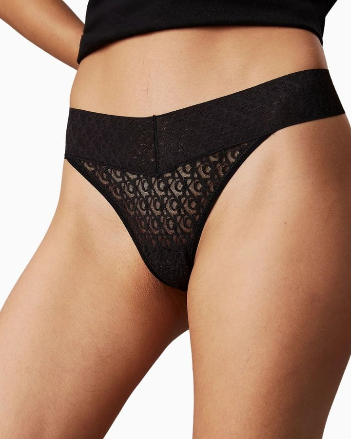 Close-up of Calvin Klein low-rise thong showing all-over logo lace pattern