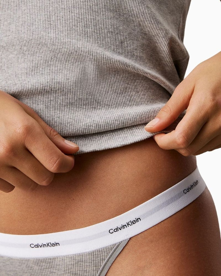 Close up view Calvin Klein 3-pack cotton stretch ribbed thongs with signature waistband