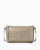 Front view of taupe Calvin Klein Bold flap crossbody bag with CK logo
