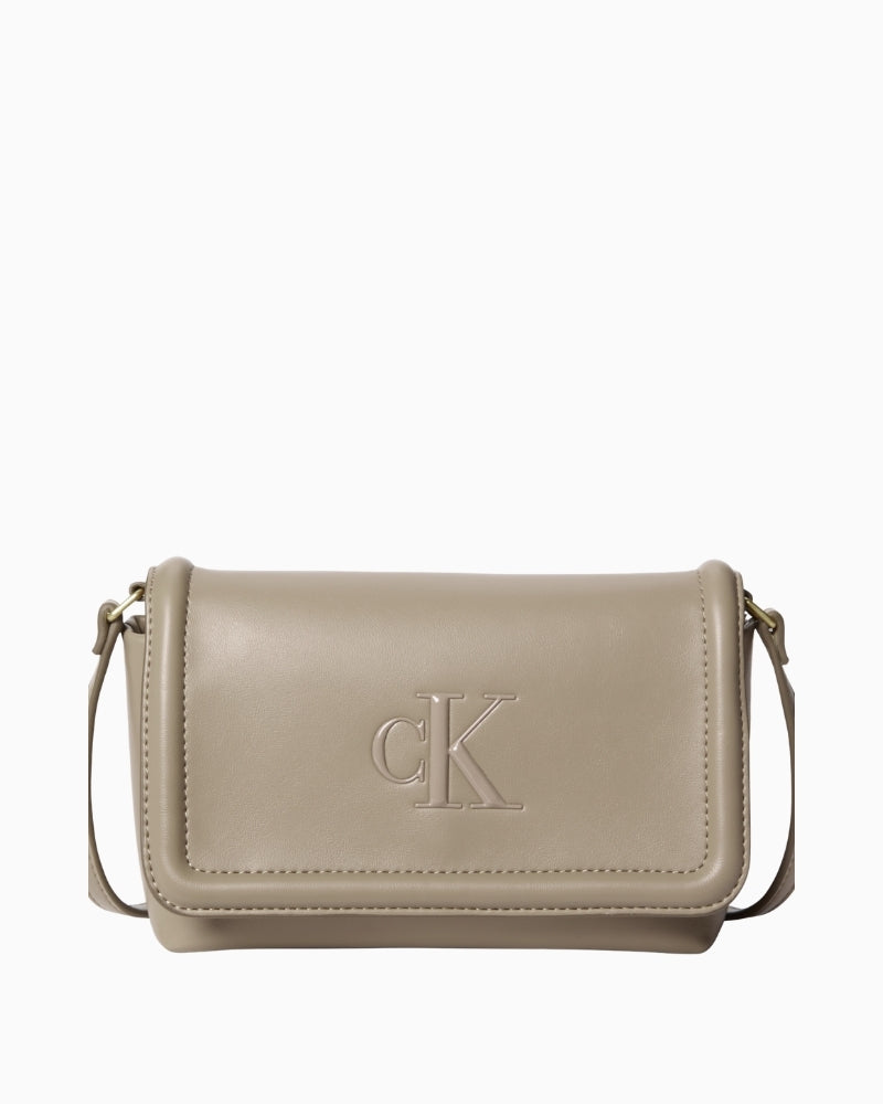 Front view of taupe Calvin Klein Bold flap crossbody bag with CK logo