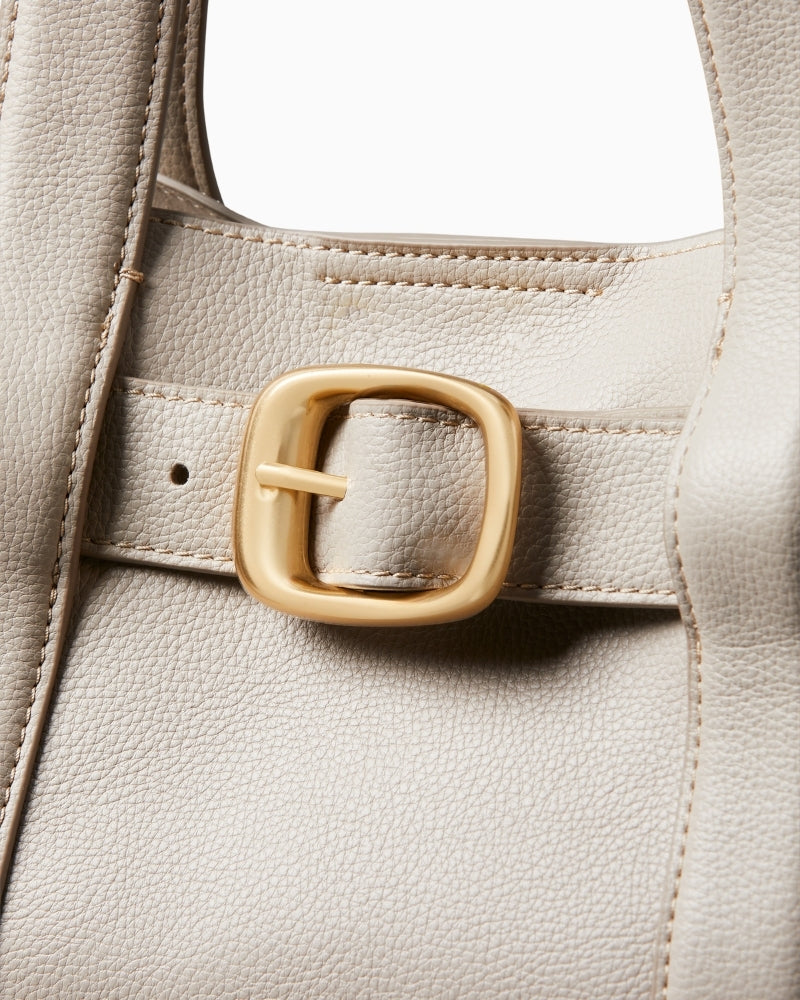 Close-up of buckle detail and textured stitching on Calvin Klein taupe bag