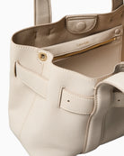 Close-up of buckle detail and textured stitching on Calvin Klein taupe bag